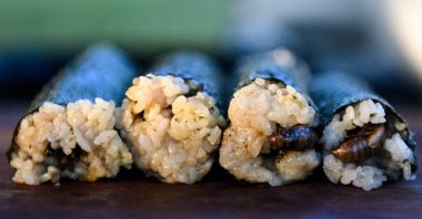 Fried cicadas are rolled into a sushi roll by Chef Bun Lai at Fort Totten Park in Washington D.C., U.S., May 23, 2021. (AFP Photo)