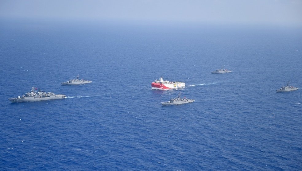 Turkey's research vessel Oruç Reis, in red and white, is surrounded by Turkish navy vessels as it sails in the west of Antalya on the Eastern Mediterranean, Turkey, Aug. 10, 2020. (AP)