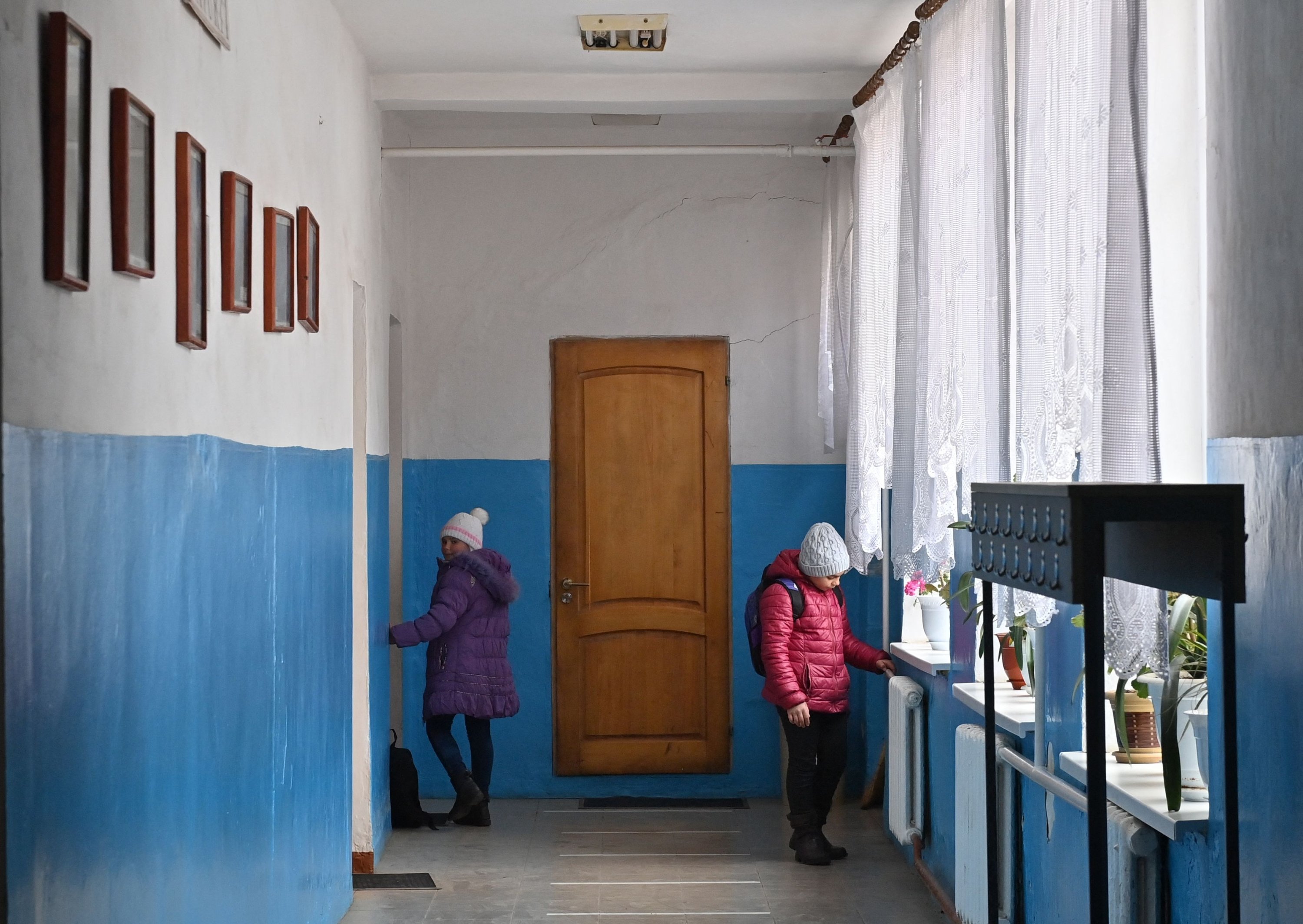 Two children stand on the hall of the local school in Bujor village, western Moldova, March 25, 2021. (AFP Photo)