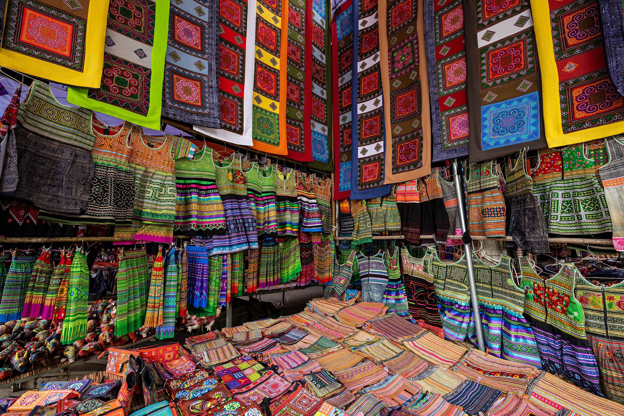 Unique and colorful clothes and fabrics wait to be sold at the largest local sunday market in Bac Ha, Lao Cai province, northwestern Vietnam, Nov. 10, 2019. (Shutterstock Photo)