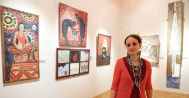 Mariya Komisa poses in front of her works from "Letter of the Traveler" at the State Museum of Oriental Art in Moscow, Russia, May 25, 2021. (AA Photo)
