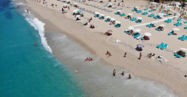 An aerial view of tourists sunbathing and swimming on a beach in Antalya, southern Turkey, May 14, 2021. (IHA Photo)