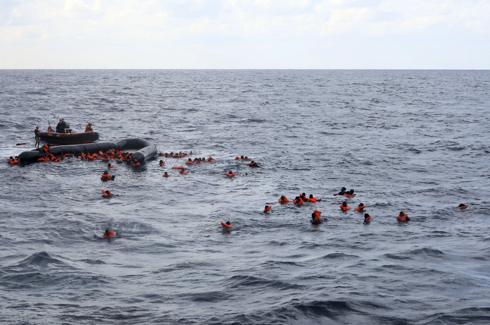 Refugees and migrants are rescued by members of the Spanish NGO Proactiva Open Arms, after leaving Libya trying to reach European soil aboard an overcrowded rubber boat in the Mediterranean sea, Wednesday, Nov. 11, 2020. (AP File Photo)