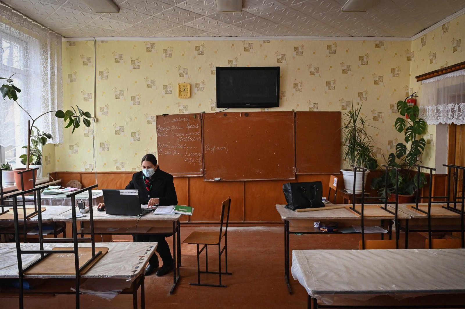 A teacher gives online classes at the local school in Bujor village, western Moldova, March 25, 2021. Around 240 kids study at the local school in Bujor, among them 48 have one parent left abroad and four of them both parents. (AFP Photo)