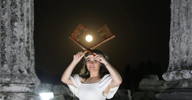 The actress portraying the goddess Hecate hold keys in front of the super moon at the Sanctuary of Hecate in Lagina, Muğla, southwestern Turkey, May 27, 2021. (AA Photo)