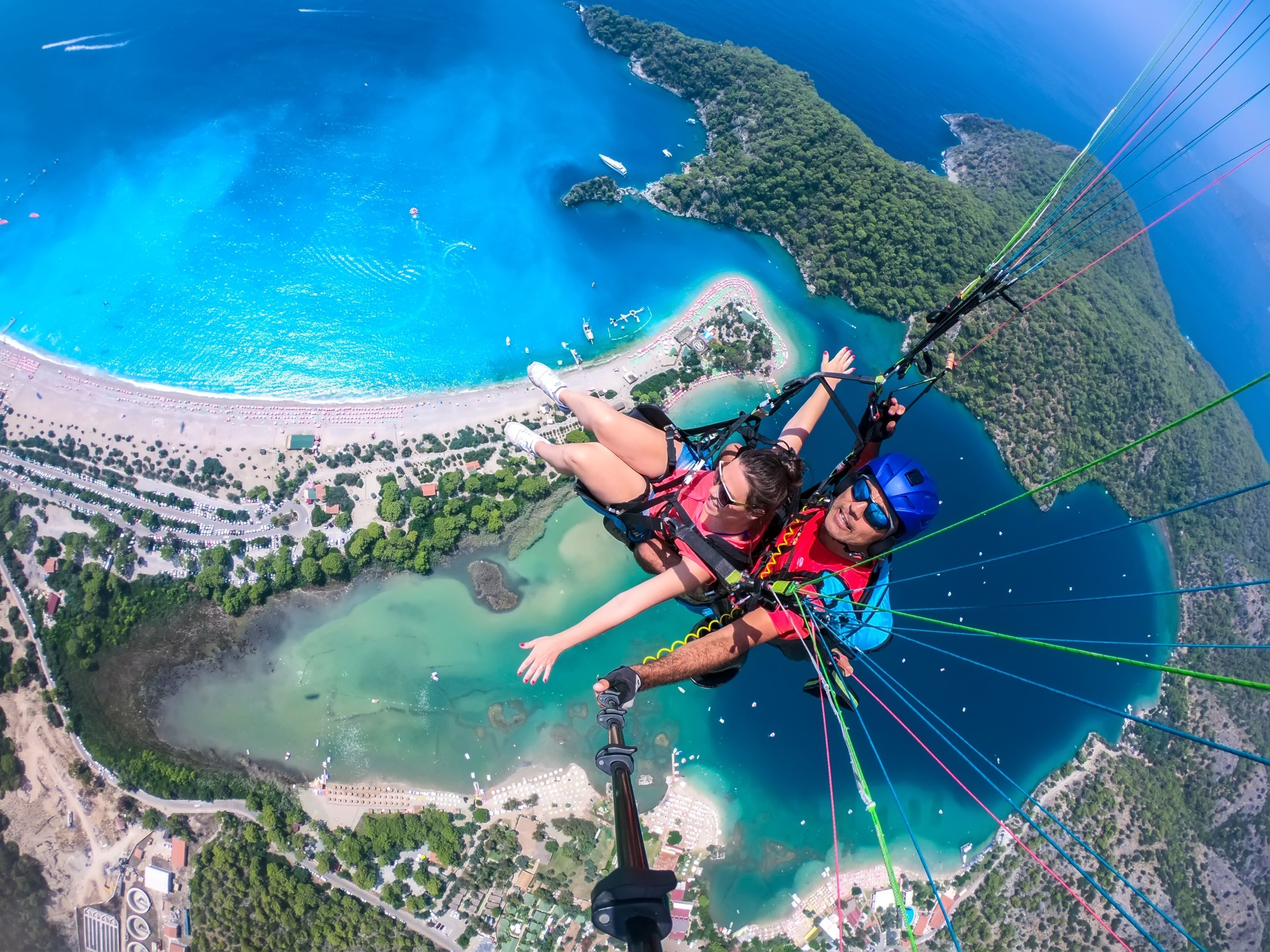 Paragliders tandem fly over the sea with its beautiful clear blue water and mountains in Ölüdeniz, Turkey,  Aug. 4, 2018. (Shutterstock Photo)
