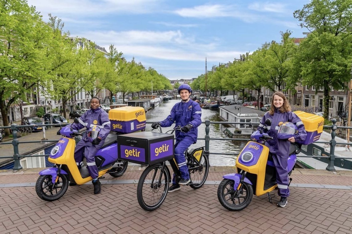 Getir couriers pose in front of a canal in Amsterdam, the Netherlands, May 28, 2021. (Courtesy of Getir)