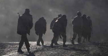 Armenian soldiers walk along the road near the border between Nagorno-Karabakh and Armenia, Sunday, Nov. 8, 2020. (AP Photo)