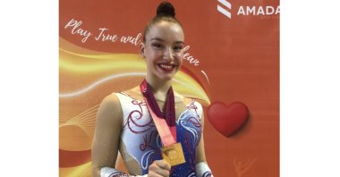 Turkish gymnast Ayşe Begüm Onbaşı posing with her gold medal won at the 16th FIG Aerobic Gymnastics World Championships in Baku, Azerbaijan, May 28, 2021. (Photo by RedBull via AA)