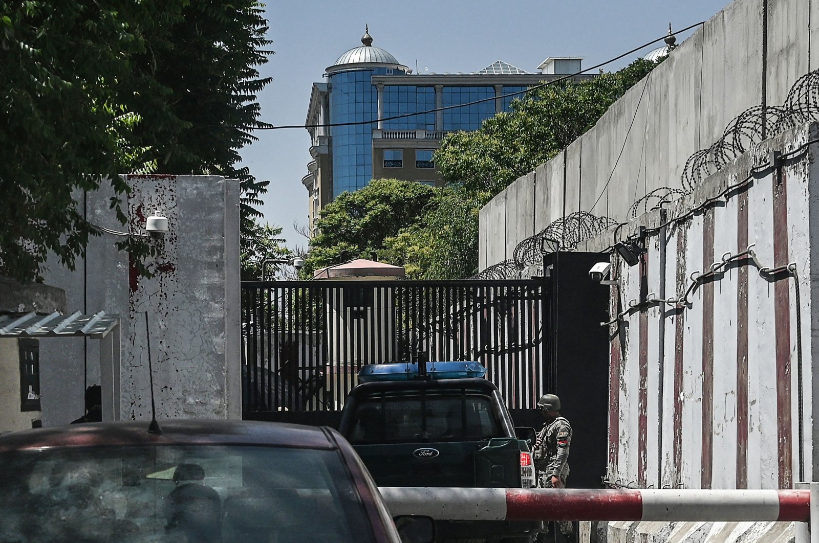 A security officer stands guard in front of an entrance gate near the Australian Embassy at the Green Zone in Kabul on May 25, 2021, after Australia abruptly announced it will shutter its embassy in Afghanistan this week over security fears as foreign troops withdraw. (AFP Photo)