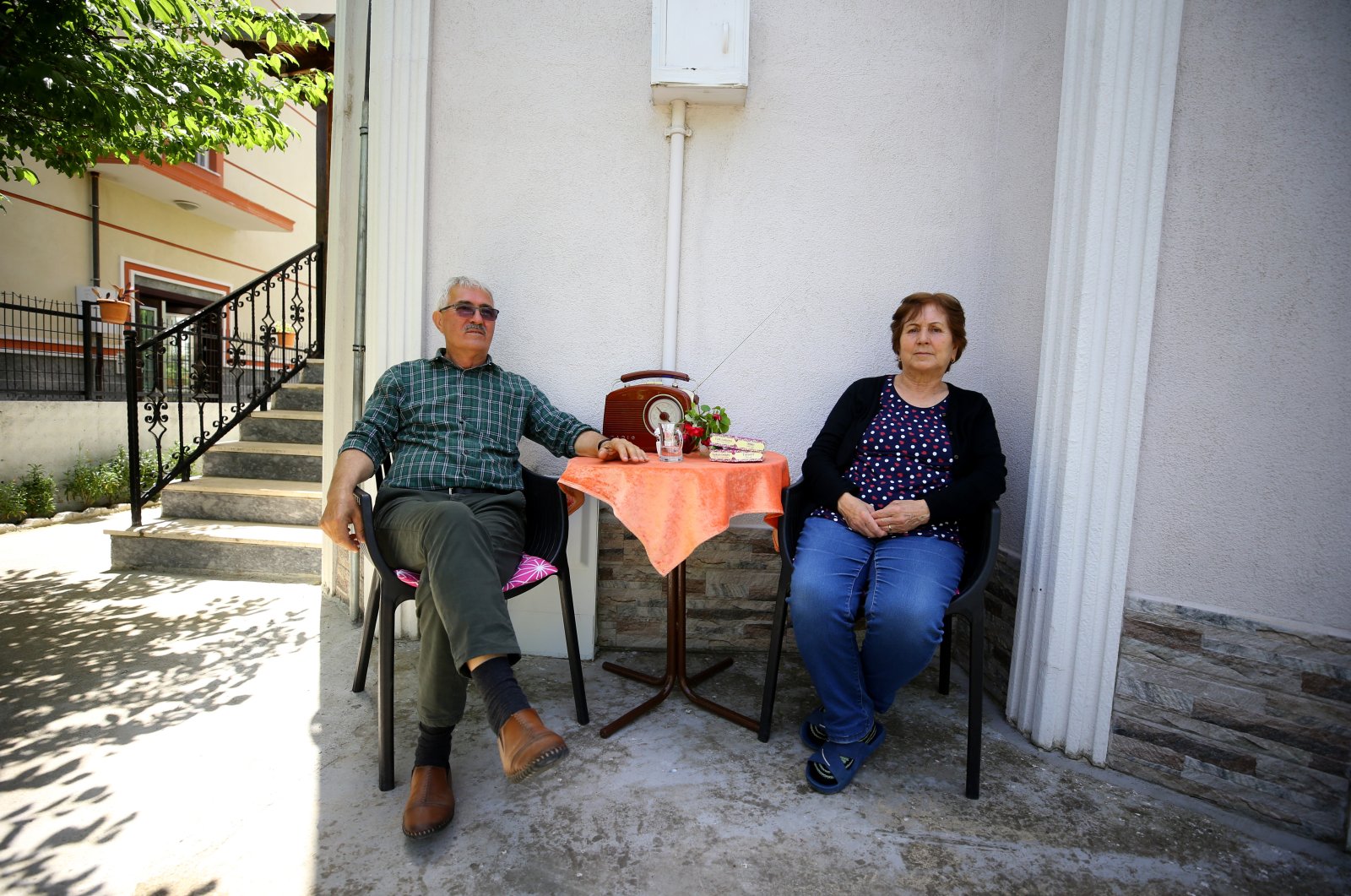 Cemil, 73, and Kıymet Birtane, 70, sit in their garden in Kırklareli province bordering Bulgaria, Edirne, Turkey, May 28, 2021. (Özgün Tiran / Anadolu Agency)