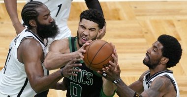 Boston Celtics forward Jayson Tatum (0) drives between Brooklyn Nets guards James Harden (L) and Kyrie Irving during the fourth quarter in Game 3 of an NBA basketball first-round playoff series Friday, May 28, 2021, in Boston. (AP Photo)