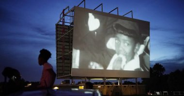 People watch the documentary "Rebuilding Black Wall Street," during a drive-in screening of documentaries during centennial commemorations of the Tulsa Race Massacre in Tulsa, Okla, May 26, 2021. (AP Photo)
