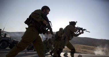 Israeli border police officers chase Palestinian demonstrators during clashes at the entrance to Duma village near the West Bank city of Nablus, Aug. 1, 2015. (AP File Photo)