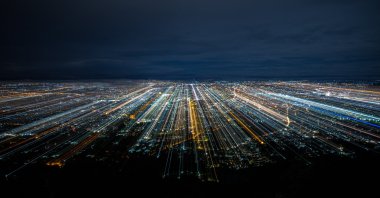 An illustration photo shows an aerial view of a city at night. (Photo by Shutterstock)