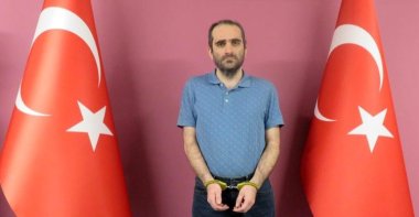 A photo of Selahaddin Gülen in handcuffs at an undisclosed location and date, provided by the National Intelligence Organization (MİT). (AA PHOTO)