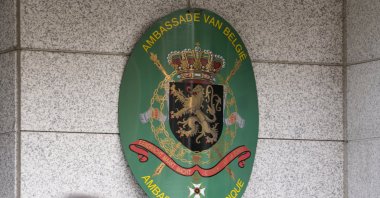 A man wearing a face mask as a precaution against the coronavirus walks past in front of the Belgium Embassy in Seoul, South Korea, May 31, 2021. (AP Photo)