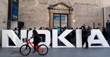 A cyclist rides past a Nokia logo during the Mobile World Congress in Barcelona, Spain, Feb. 25, 2018. (Reuters Photo)