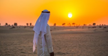 An illustration photo showing a man looking at the sunset in a desert in the Arab region. (Photo by Shutterstock)