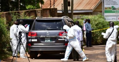 Forensic experts secure the scene of an attempted assassination on Ugandan minister of works and transport General Katumba Wamala, in which he was wounded and his daughter and driver killed, near Kampala, Uganda June 1, 2021. (Reuters Photo)