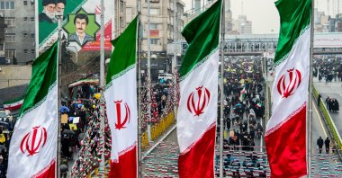 Demonstrators fill the street as Iranian national flag banners fly during the 40th anniversary of the Islamic revolution in Tehran, Iran, Feb. 11, 2019. (Photo by Getty Images)