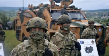 Turkish soldiers are seen standing in front of new domestically-produced armored vehicles in Cincu, Romania, June 1, 2021. (AA Photo)