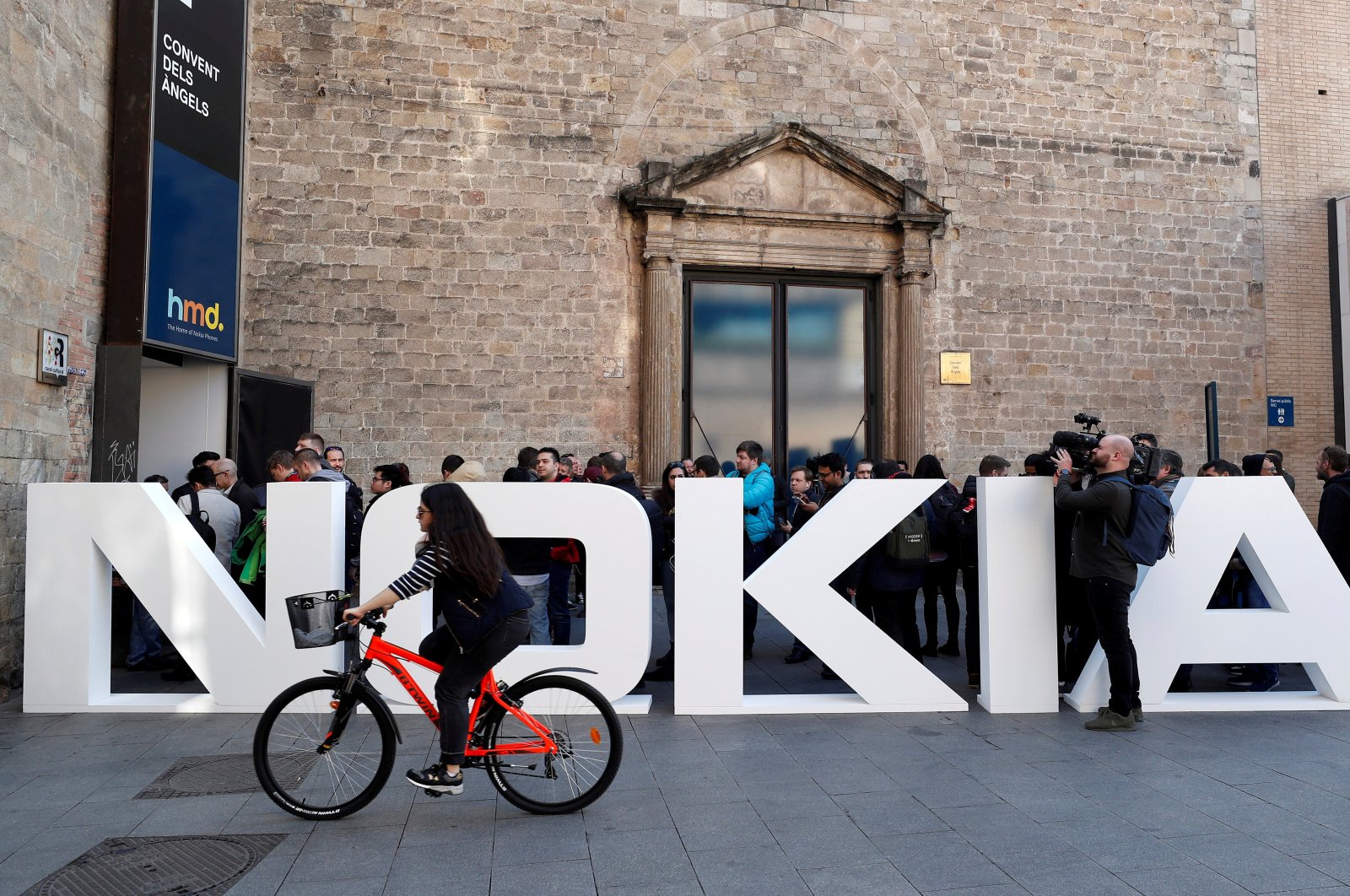 A cyclist rides past a Nokia logo during the Mobile World Congress in Barcelona, Spain, Feb. 25, 2018. (Reuters Photo)