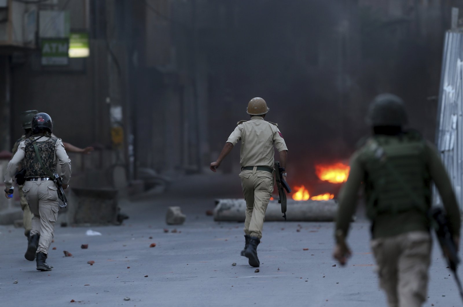 Indian police officers chase Kashmiris during a protest in Srinagar, Indian-controlled Kashmir, June 21, 2018. (AP Photo)