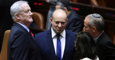 Defense Minister and leader of Blue and White party Benny Gantz (L) speaks to Yamina leader Naftali Bennett (C) during a special session of the Knesset, Jerusalem, Israel, June 2, 2021. (Reuters Photo)