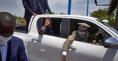 The president of Mali's transitional government, Col. Assimi Goita, waves from his vehicle as he returns from Accra where he met with Economic Community of West African States (ECOWAS) representatives, in Mali, May 31, 2021. (AFP Photo)