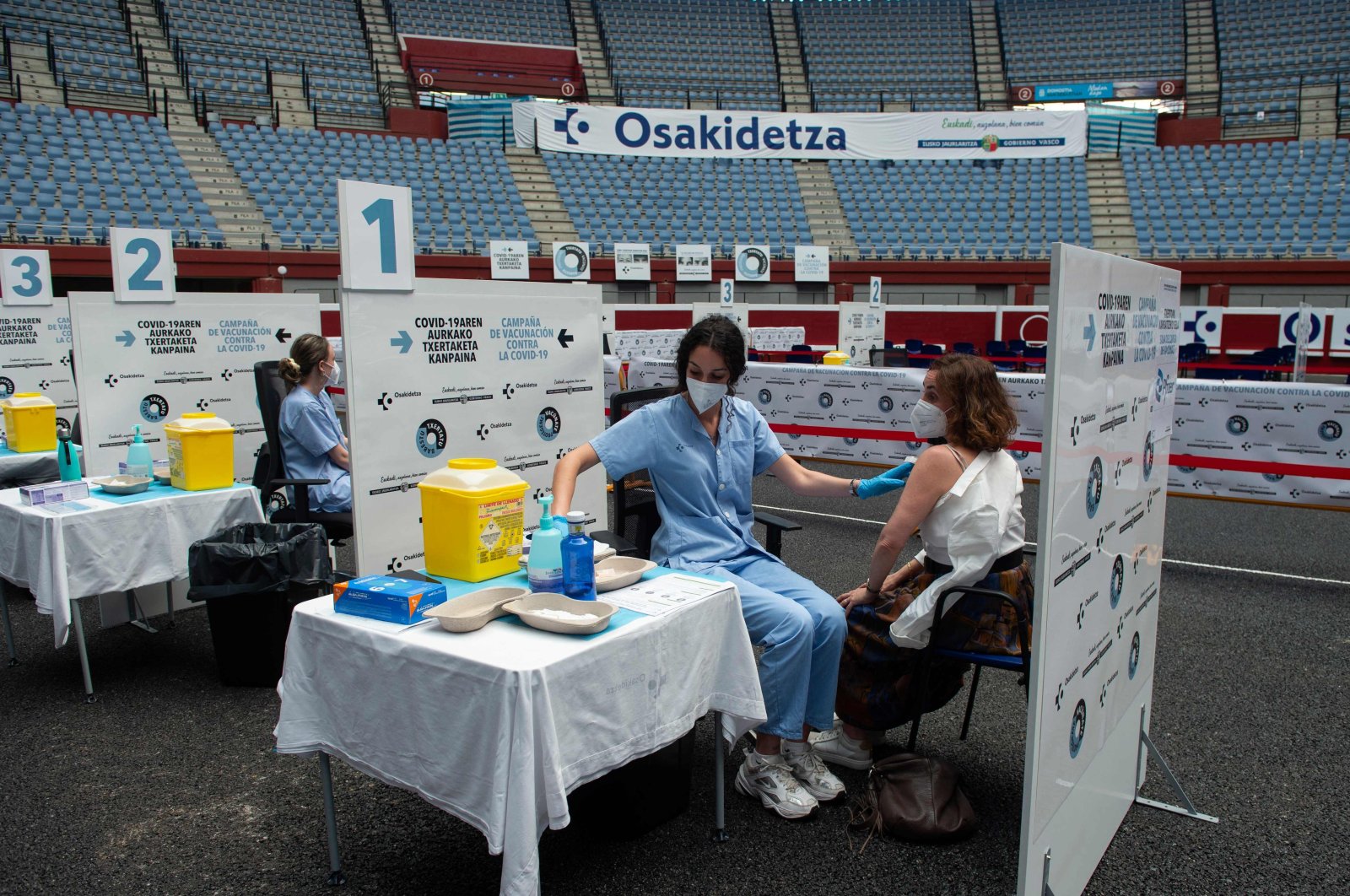 Health workers vaccinate people against COVID-19 at the Donostia Arena former bullring in San Sebastian, Spain, May 31, 2021. (AFP Photo)