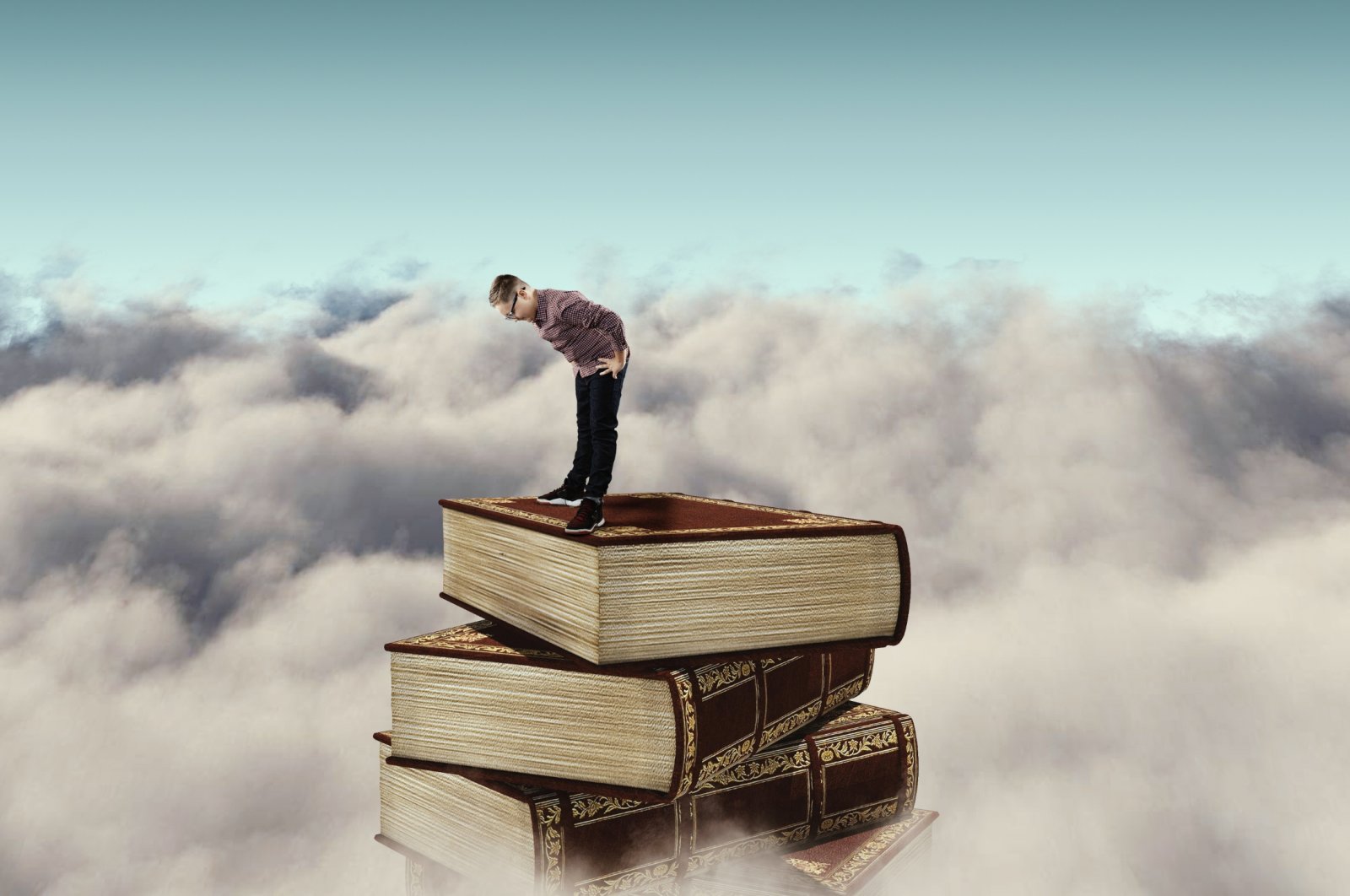A digital illustration shows a child standing on a stack of books above the clouds. (Shutterstock Photo)