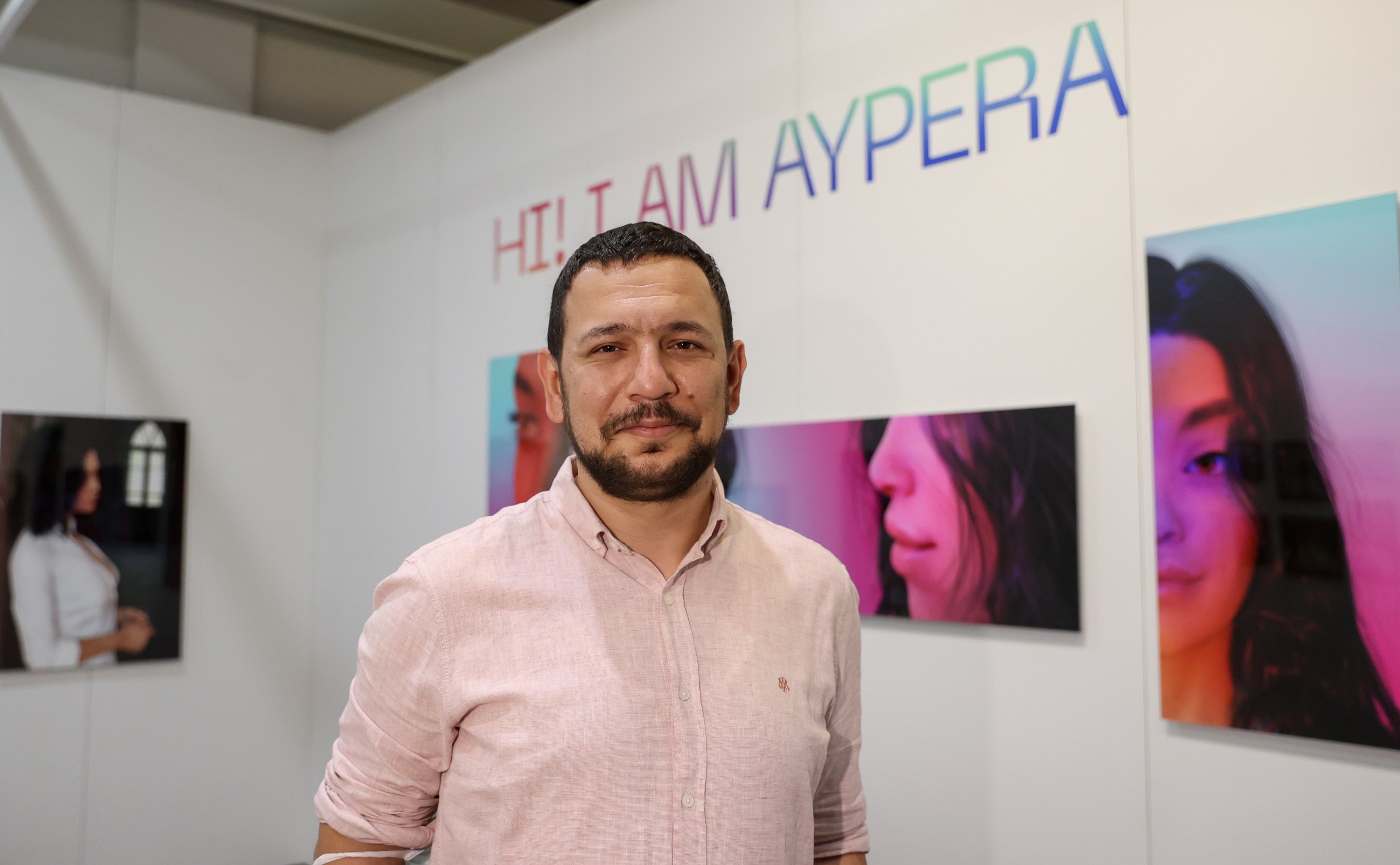 Science communicator Tevfik Uyar poses in front of the Aypera poster exhibition at Contemporary Istanbul, Istanbul, Turkey, June 2, 2021. (AA Photo)