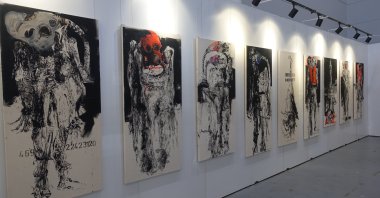 Various twisted and warped depictions of human-like figures wearing masks are on exhibit in the ArtContact Istanbul Art Fair, Istanbul, Turkey, May 31, 2021. (AA Photo)