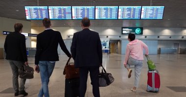 People look at the information board at Domodedovo Airport in Moscow, Russia, June 2, 2021. (EPA Photo)