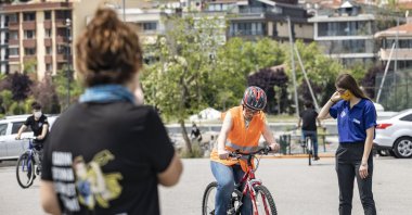 The group's members teach a woman how to ride, in Istanbul, Turkey, June 3, 2021. (AA PHOTO)
