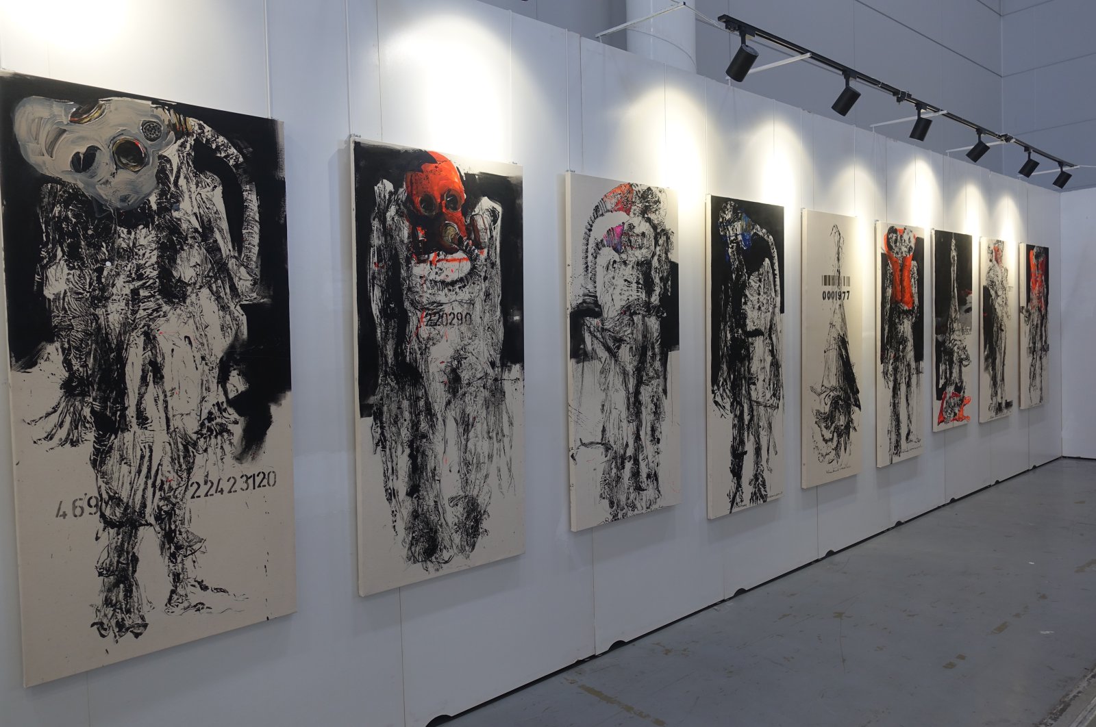 Various twisted and warped depictions of human-like figures wearing masks are on exhibit in the ArtContact Istanbul Art Fair, Istanbul, Turkey, May 31, 2021. (AA Photo)