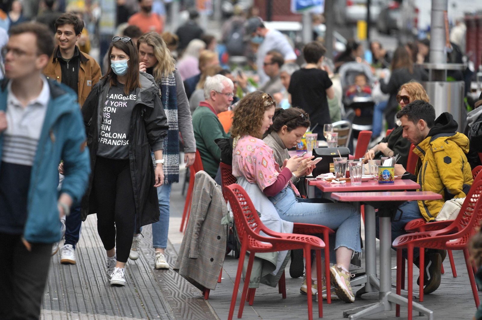 Members of the public enjoy refreshments at tables set up outside a cafe in south Kensington, London, U.K., May 18, 2021. (AFP Photo)