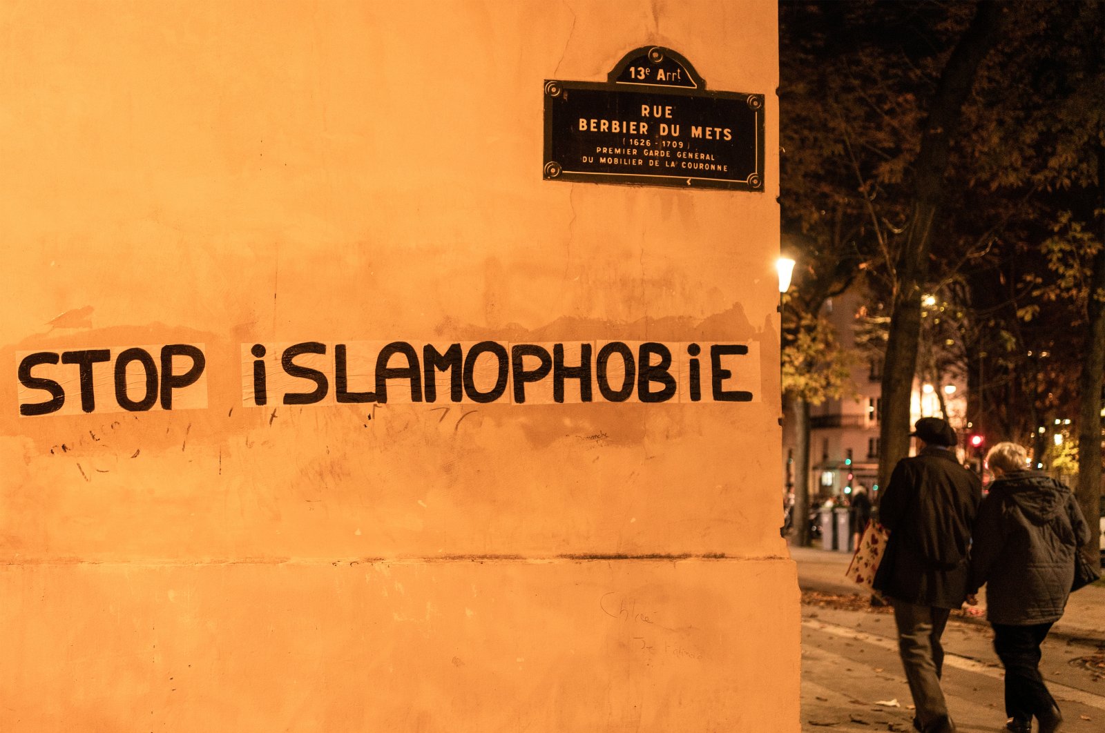 People walk past a graffito that reads "Stop Islamophobia" in Paris, France, Oct. 26, 2020. (Getty Images)