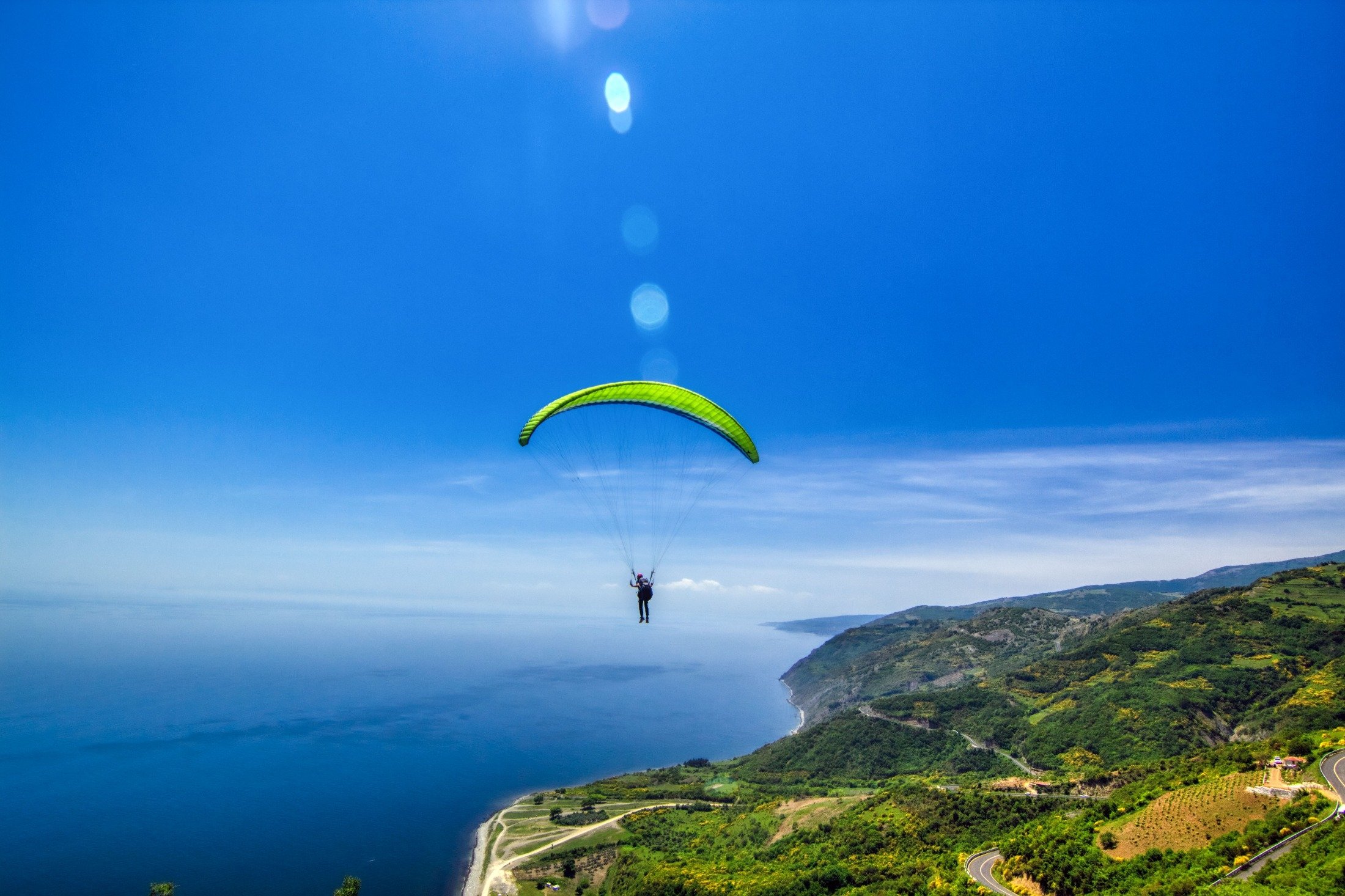 A man paraglides from Mount Ganos