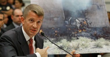 Erik Prince, chairperson of the Prince Group, LLC and Blackwater, holds up a picture showing the affect of a car bomb while testifying during a House Oversight and Government Reform Committee hearing on Capitol Hill, Oct. 2, 2007 in Washington D.C., U.S. (Getty Images)