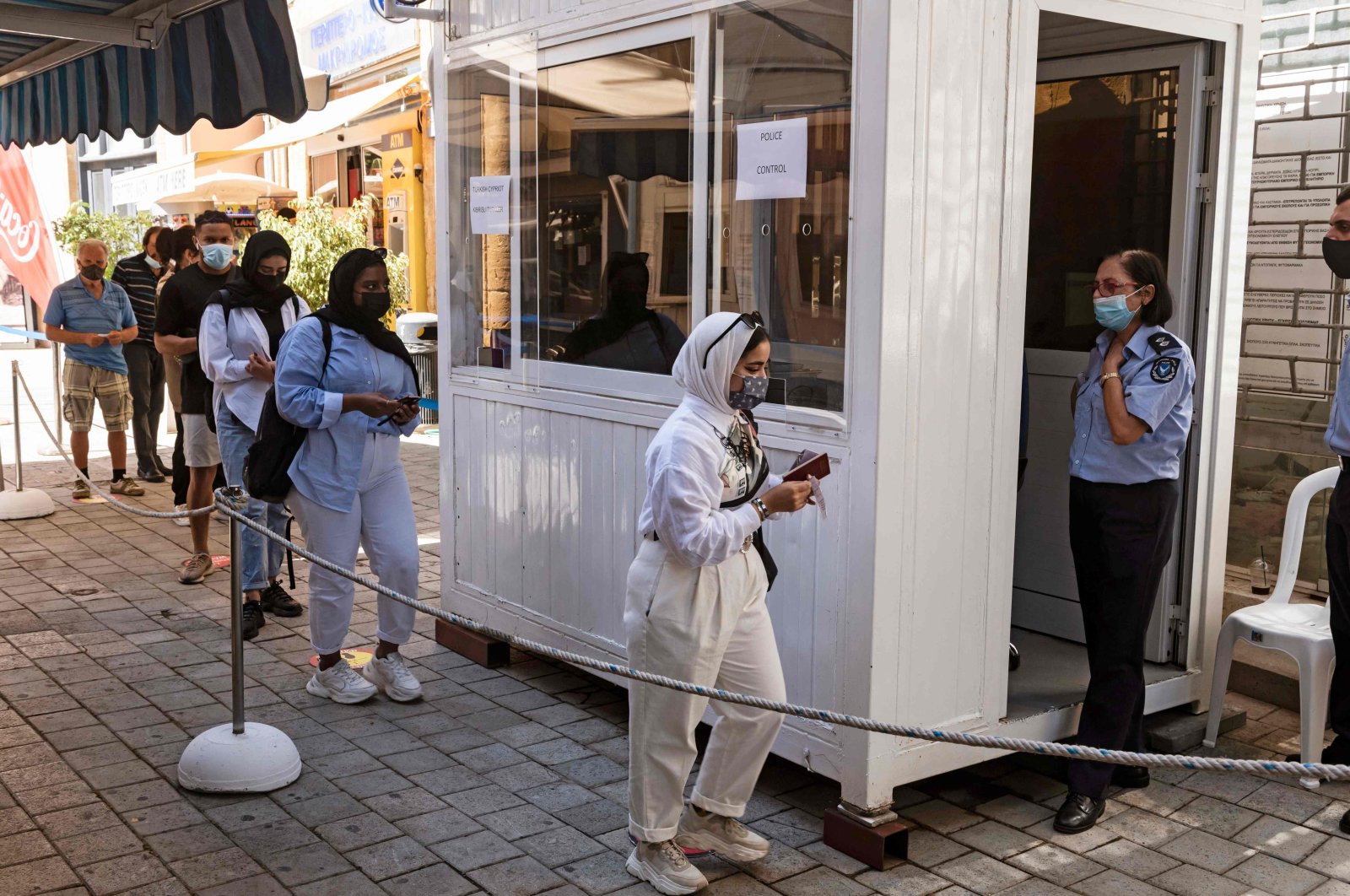 Following the easing of restrictions on the divided island amid the COVID-19 pandemic, people move through the Ledras crossing point from the southern Greek Cypriot administration toward the Turkish Republic of North Cyprus (TRNC), on June 4, 2021. (AFP Photo)
