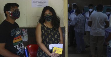 Students wait to receive the AstraZeneca vaccine during a special vaccination drive for students traveling abroad for studies in Hyderabad, India, June 5, 2021. (AP Photo)