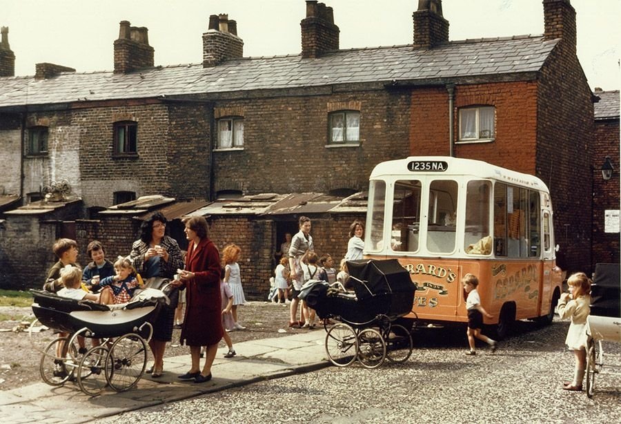 Shirley Baker, "Ice cream van on a terraced street, Manchester," 1965, color photograph, 34 by 51 centimeters. (Courtesy of the British Council)