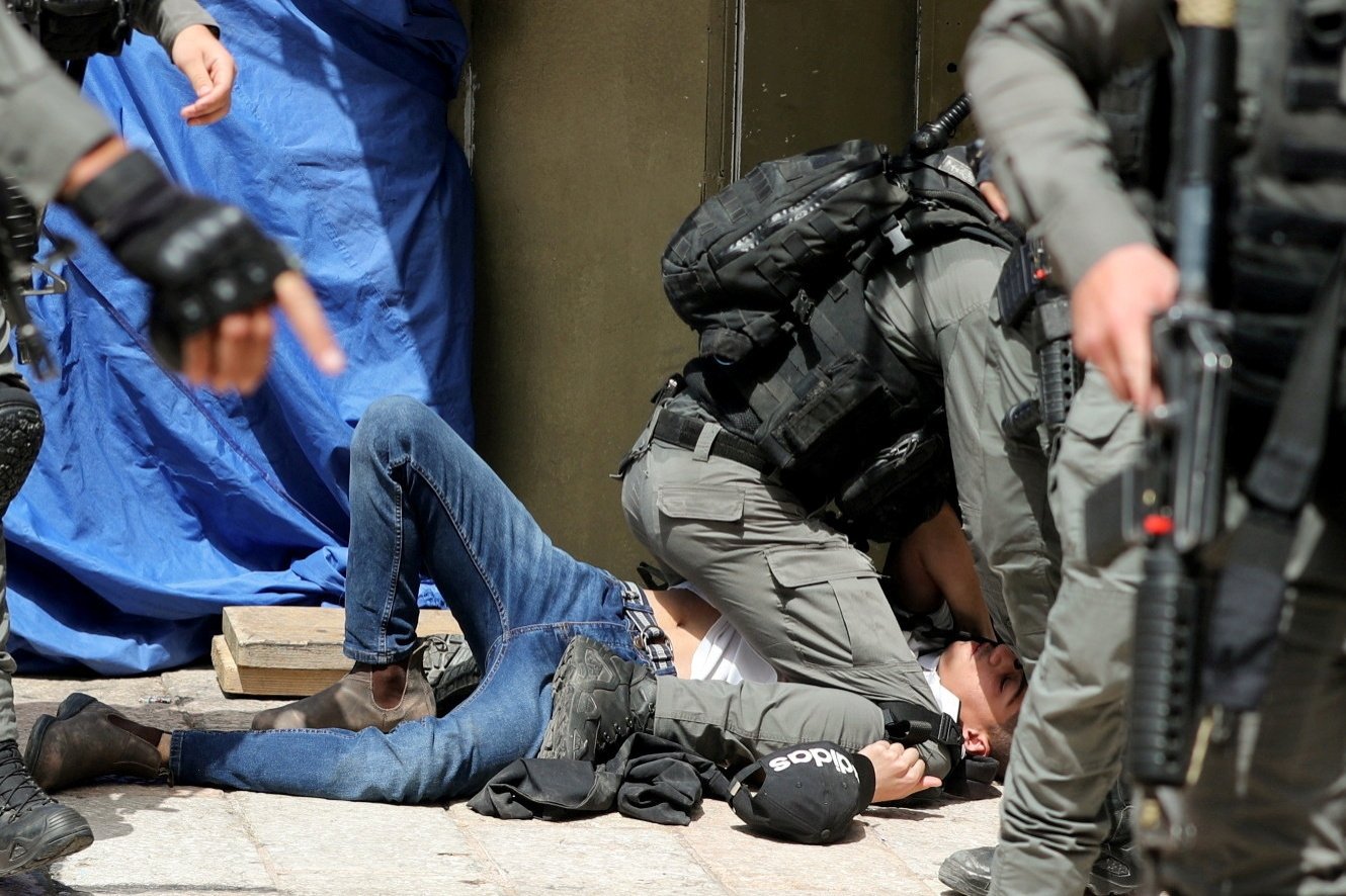 Israeli police detain a Palestinian during clashes at the compound that houses Al-Aqsa Mosque, in the Old City, East Jerusalem, occupied Palestine, May 10, 2021. (Reuters Photo)