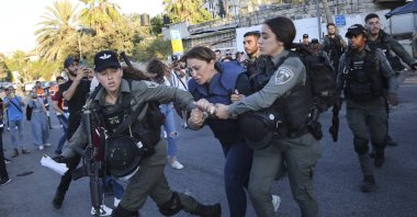 Israeli forces arrest Al Jazeera journalist Givara Budeiri during a protest in the Sheikh Jarrah neighborhood of East Jerusalem, occupied Palestine, Saturday, June 5, 2021. (AP Photo)