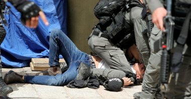 Israeli police detain a Palestinian during clashes at the compound that houses Al-Aqsa Mosque, in the Old City, East Jerusalem, occupied Palestine, May 10, 2021. (Reuters Photo)