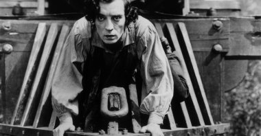 American actor Buster Keaton clinging to the front of a train in a still from the film, "The General," directed by Keaton and Clyde Bruckman, released in 1926.  (Getty Images)
