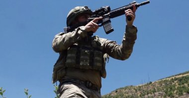 A Turkish soldier holds a gun in this undated photo, in an undisclosed location. (DHA Photo)