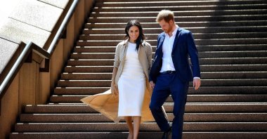  Britain's Prince Harry and his wife Meghan walk down the stairs of the iconic Opera House in Sydney to meet people, Oct. 16, 2018. (AFP File Photo)